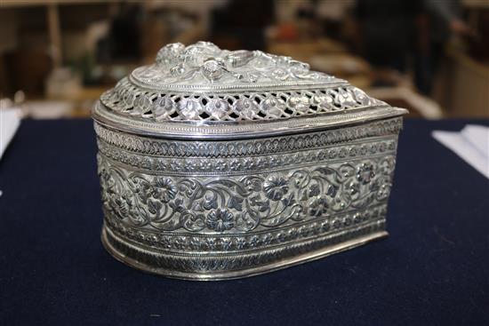 A Burmese silver teardrop shaped box with pierced cover containing minor items of jewellery.